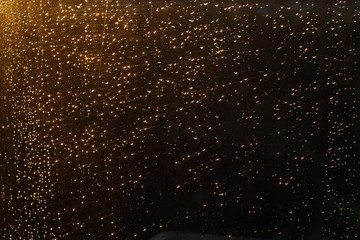 Rain drops on window with blured background.