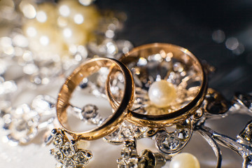 Wedding rings and shiny jewelry of the bride
