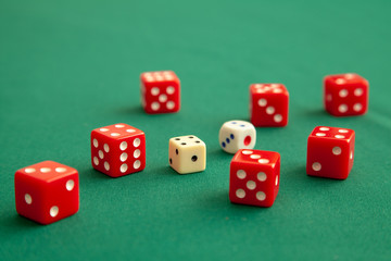 Red dices on green poker gaming table in casino. Concept online gambling