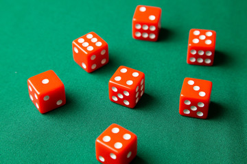Red dices on green poker gaming table in casino. Concept online gambling