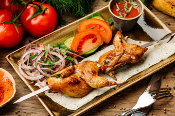 quail on skewer on the grill close-up