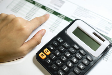 Close up woman using calculator with space for you design, selective focus.