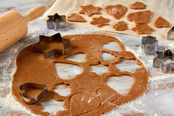 Raw gingerbread dough rolled out on table