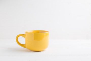 Yellow mug empty blank for coffee or tea.
