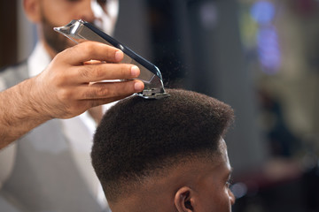 Closeup of process of trimming of hair in barber shop