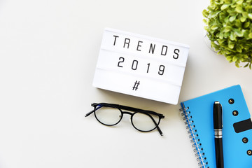 TRENDS 2019 text on lightbox composition on white table background copy space,Business Concept.