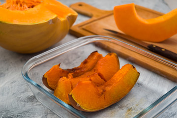 Vegetarian food. Baked pumpkin in a glass bowl. Light background. Cooking vegetables. Diet food.