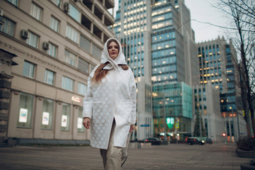 Young stylish woman walking street