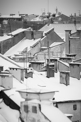 Fototapeta premium Krakow in Christmas time, aerial view on snowy roofs in central part of city. BW photo. Poland. Europe.