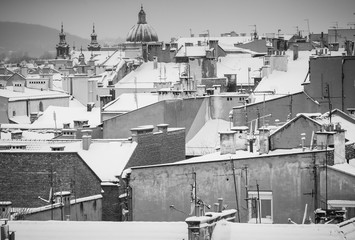 Krakow in Christmas time, aerial view on snowy roofs in central part of city. BW photo. Poland. Europe.