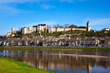 Fototapeta na wymiar Chinon town and chateau on the hill above by the banks of the Vienne River in spring sunshine, Indre-et-Loire, France
