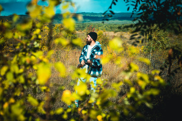 Hunter with shotgun gun on hunt. Poacher with Rifle Spotting Some Deers. Illegal Hunting Poacher in the Forest.