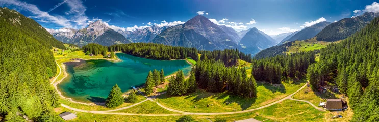 Fotobehang Arnisee with Swiss Alps. Arnisee is a reservoir in the Canton of Uri, Switzerland, Europe © Eva Bocek