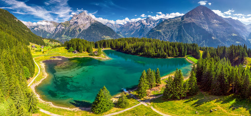 Naklejka premium Arnisee with Swiss Alps. Arnisee is a reservoir in the Canton of Uri, Switzerland, Europe