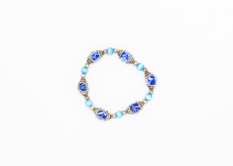 blue colored and variously sized beads bracelet on white background