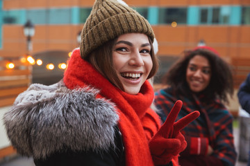 Happy young friends talking with each other outdoors winter concept.