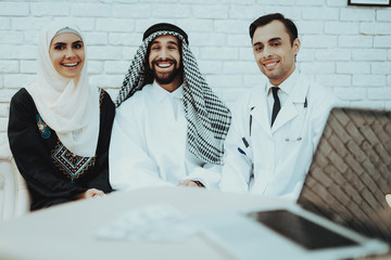 Smiling Arabic Family and Doctor Looking in Camera