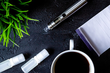 concept of electronic cigarette on dark background top view