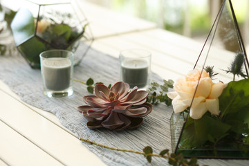 Florarium with fresh succulent and rose flowers festive table decoration. Event fresh flowers decoration. Florist workflow. Wedding ceremony  design