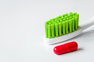 concept toothache with toothbrush and pills at white background