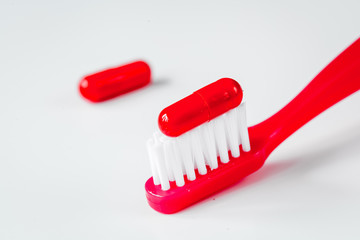 concept toothache with toothbrush and tablet at white background