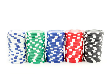 Casino games concept,Stacks of poker chipson gamble table including red, black, white, green and blue on a white background.