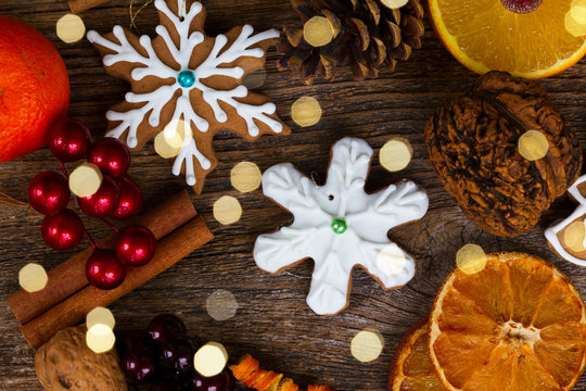 christmas gingerbread snowflake cookie with otanges, spices and decorations