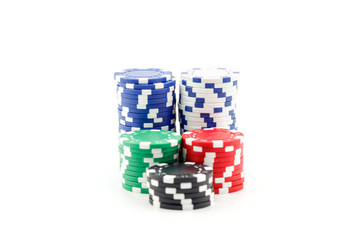 Casino games concept,Stacks of poker chipson gamble table including red, black, white, green and blue on a white background.