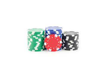 Casino games concept,Stacks of poker chipson gamble table including red, black, white, green and blue on a white background.
