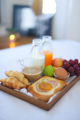 Breakfast on bed with coffee, croissants Window light
