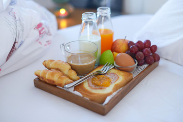 Breakfast on bed with coffee, croissants Window light
