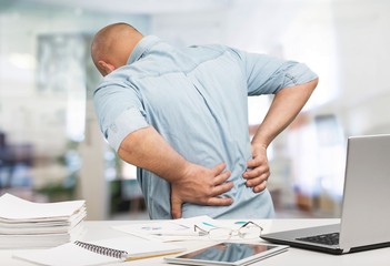 Business man with back pain an office