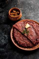 Ragi Roti made from finger millet from India is extremely rich in proteins served with pickle or achar. selective focus