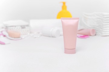 Baby cream on the background of other means of care for the newborn.