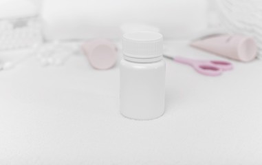 Bottle with baby powder on the table with other means.