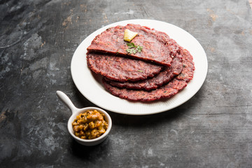 Ragi Roti made from finger millet from India is extremely rich in proteins served with pickle or achar. selective focus