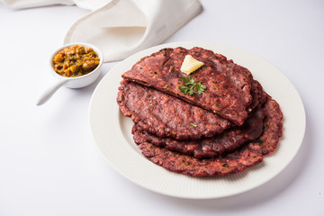 Ragi Roti made from finger millet from India is extremely rich in proteins served with pickle or achar. selective focus