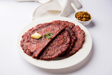 Ragi Roti made from finger millet from India is extremely rich in proteins served with pickle or achar. selective focus