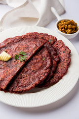 Ragi Roti made from finger millet from India is extremely rich in proteins served with pickle or achar. selective focus