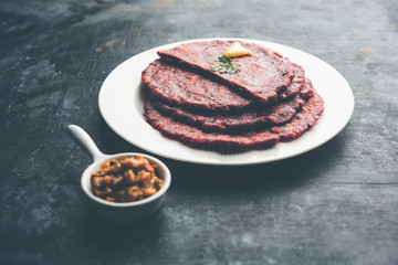 Ragi Roti made from finger millet from India is extremely rich in proteins served with pickle or achar. selective focus