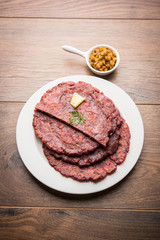 Ragi Roti made from finger millet from India is extremely rich in proteins served with pickle or achar. selective focus