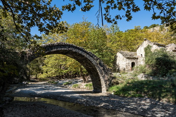 Fototapeta na wymiar View of a traditional stone bridge and a ruined watermill near Elassona in Thessaly, Greece