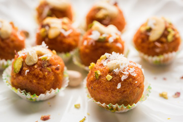 Carrot Halwa Laddu or sweet balls,  served in a plate with dry fruits toppings. selective focus