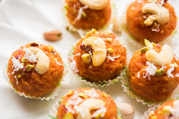 Carrot Halwa Laddu or sweet balls,  served in a plate with dry fruits toppings. selective focus