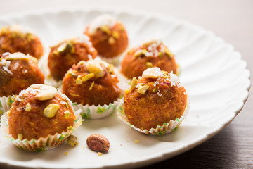 Carrot Halwa Laddu or sweet balls,  served in a plate with dry fruits toppings. selective focus