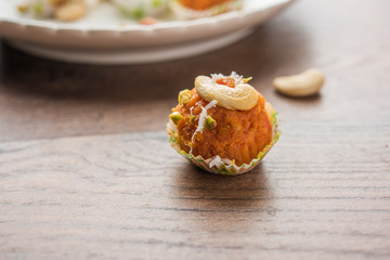 Carrot Halwa Laddu or sweet balls,  served in a plate with dry fruits toppings. selective focus