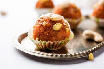 Carrot Halwa Laddu or sweet balls,  served in a plate with dry fruits toppings. selective focus