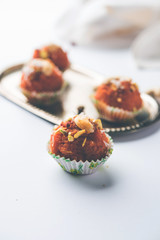 Carrot Halwa Laddu or sweet balls,  served in a plate with dry fruits toppings. selective focus