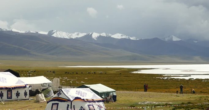 4k huge clouds mass rolling over lake namtso,tibet mansarovar,herdsman tent,a group of cow,Tibet's second largest lake,is the third largest saltwater lake in China.