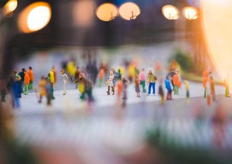miniature people walking on streets,people are moving across the pedestrian crosswalk in the city...